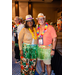  A man and a women wearing leis, hats, and grass skirts. 