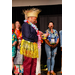  Anthony Goodson, Jr. wearing a full Hawaiian themed outfit and smiling while holding a glass award. 