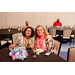  Two woman sitting at a table with their finished plates in front of them. 