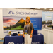  A woman stands in the SACS Software booth. Advancing the housing industry since 1969.  