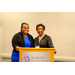  Two women stand behind the podium and smile for a photo. 