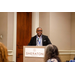 James Cox speaking behind a podium that says Sheraton Greensboro. 