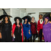  Five women in various witch costumes standing with a man in a double breasted brocade waistcoat. 