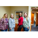  Four woman posing for a photo together. 