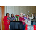  Four women smiling and holding up signs around a table. The signs include I was Framed, Guilty, I Suspect Foul Play, Too Pretty For Murder, It wasn't Me, and The Usual Suspects.  