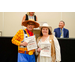  A man in a Woody Costume and Shannon Young in a western costume holding Best Dressed Winner Certificates. 