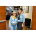  Two women in cowboy hats and denim jackets smiling for the camera. 