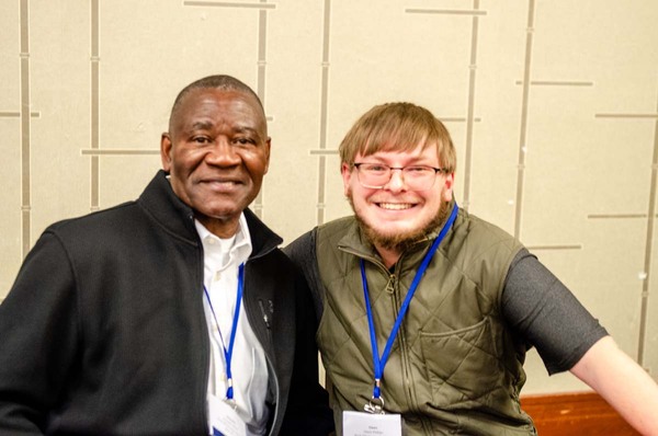 Two men smiling big for the camera.