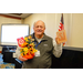 Another man holding a pumpkin with a scarecrow and gift card prize and a winning bingo card. 